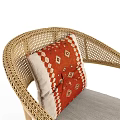 Stylish Natural Rattan Armchair With Red Geometric Cushion And Woven Accents