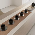 Modern Minimalist Tea Set Arrangement With Black Teacups And Teapot On Wooden Table