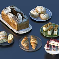 Assorted Fresh Bread Loaves Rolls Croissants Slices And Cakes On Plates