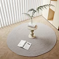 Cozy Living Room Light Colored Side Table On Round Rug With Potted Plant And Books