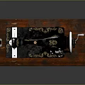 Vintage Black Sewing Machine With Gold Decorations On Wooden Base