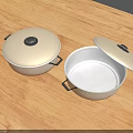 Stainless Steel Cooking Pots With Open And Closed Lids On Wooden Tabletop
