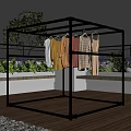 Metal Frame Clothes Drying Rack With Hanging Clothes On Outdoor Balcony