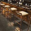 Row of Wooden Bar Stools With White Cushions At Modern Bar Counter