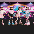 Kids Roller Skating Indoors With Colorful Wall Wearing Pink Helmets And Protective Gear