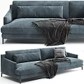 Modern Blue Two Seater Sofa With Gray Blanket And Decorative Cushions In Contemporary Design