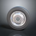 Car Tire With Silver Metal Rim And Tread Pattern On Dark Background