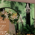 Forest Themed Photo Spot With Green Backdrop Floral Arch White Chandeliers And Green Plants