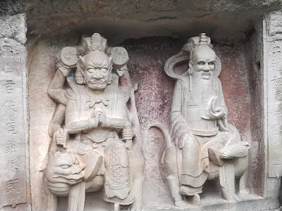 Stone Sculptures of Two Deities in Traditional Attire Carved on Ancient Stone Wall 3d model