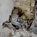 Fire Damaged Kitchen Interior Showing Burned Walls Broken Appliances And Debris