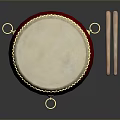 Traditional Red Drum With White Head Golden Decorations And Wooden Drumsticks