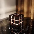Modern Cube Table Lamp With Warm Lighting On Black Marble Tabletop And Metal Accents