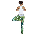 Woman Doing Tree Yoga Pose In White Tank Top And Tropical Leaf Print Leggings