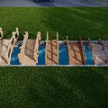Wooden Arched Landscape Bridge With Water Underneath Green Grass And Trees