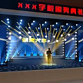 College Award Ceremony Stage With Person Standing And Bright Stage Lights