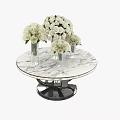 Round Marble Top Coffee Table With Black Base Glass Vases And White Roses