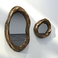Two Irregular Shaped Golden Mirrors On White Wall With Shadow Effects