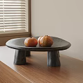 Three Orange Oranges on Black Stone Table Placed on Wooden Countertop by Window with Blinds