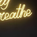 Glowing Yellow Simply Breathe Neon Sign Decor On Dark Wall