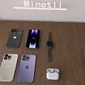 Apple Smartphones In Black White Purple With Smartwatch And Wireless Earbuds On Wooden Table