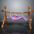 Purple and pink fish hanging on wooden structure made with sticks and ropes