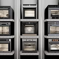 Modern Built in Kitchen Appliances With Stacked Vertical Ovens On Multi Layer Shelves