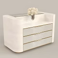 White Wooden Cabinet With Three Drawers Gold Trim And Vase Of White Flowers