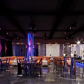 Stylish Bar Interior With Colorful Lighting High Tables And Comfortable Chairs