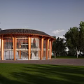 Traditional Ancient Building Featuring Circular Roof Wooden Frame Glass Walls Surrounded By Grassland And Trees