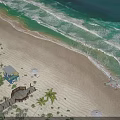 Aerial View Of Serene Tropical Beach Scenery With Palm Trees And Gentle Turquoise Ocean Waves