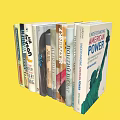 Stack of Various Books With Colorful Covers and Titles on Yellow Background