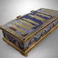 Antique Ornate Decorative Box Featuring Intricate Golden Figure Reliefs On Blue Background