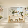 Bright Flower Shop Interior With Wooden Table Stools And Shelves Of Fresh Bouquets