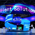 Orient Solutions Exhibition Booth With Large Curved LED Screen And Colorful Lighting