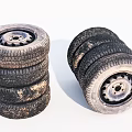 Old Stacked Vehicle Tires With Metal Rims And Worn Tread Patterns