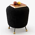 Black Plush Sofa Stool With Metal Legs And Gold Spherical Feet Topped With Book