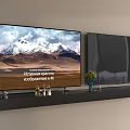 TVs With Snowy Mountain Display And Decorative Items On Black Shelf Against Light Wall
