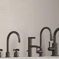 Different Styles Of Black Metal Faucets On Countertop With Wall Background