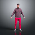 A man standing against gray background in dark purple jacket pink pants and silver shoes