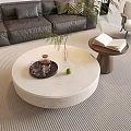 Modern Living Room Interior Featuring Round Coffee Table Grey Sofa Green Plant And Books