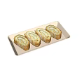 Four Sliced Rolled Food With Cream Filling And Golden Crust On Light Colored Rectangular Tray