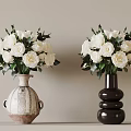 Two Decorative Vases With White Roses And Green Leaves On Light Surface
