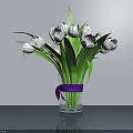 White Tulips in Transparent Glass Vase With Purple Ribbon on Gray Tabletop