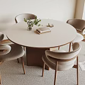 Modern Round Dining Table with Light Gray Chairs Wooden Legs Green Plant Book and Candles