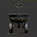 Blue Vintage Wheelbarrow with Four Rustic Wheels on Brown Mat Against Dark Background