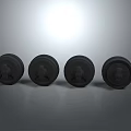 Four Black Round Baked Food Items Arranged On Gray Background With Soft Lighting