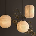 Woven Pendant Lights With Round And Cylindrical Shapes And Golden Leaf Branches On Dark Background