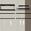 Black Clothes Drying Racks With Hanging Rods And White Towels On Wall