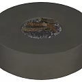 Modern Round Concrete Fire Pit With Wood Logs And Black Stones