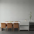 Dining Table Set with Brown Chairs and White Side Cabinet Featuring Plant on Gray Wall